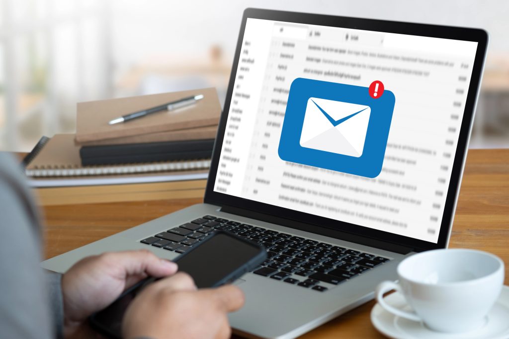 Business owner reviewing a suspicious email alert on a laptop